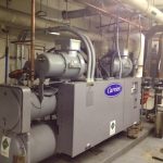 A large industrial air conditioning unit installed on the exterior of a commercial building, showcasing its robust design.