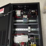 A black box containing various wires and electronic components, showcasing intricate internal circuitry and connections.