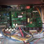 A detailed circuit board featuring various electronic components and interconnected wires, showcasing intricate technology.