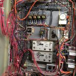 A large electrical box filled with various wires, showcasing a complex network of connections and electrical components.