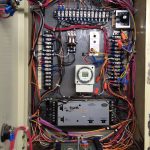 A box containing various wires and electrical components, showcasing an organized assembly of electronic parts.