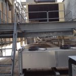 A large industrial air conditioning unit installed on the exterior of a commercial building, showcasing its robust design.