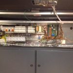 A metal cabinet housing various electrical equipment, showcasing organized components and wiring for efficient use.