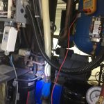 A machine featuring a hose connected to it, designed for various industrial or cleaning applications.