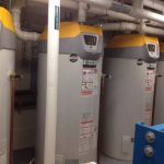 A spacious room filled with numerous water heaters arranged neatly in rows, showcasing their various sizes and designs.