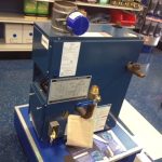 A blue and white machine positioned on a table, showcasing its sleek design and modern features.