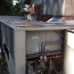 A large air conditioner positioned outside a residential home, providing cooling for the interior space.